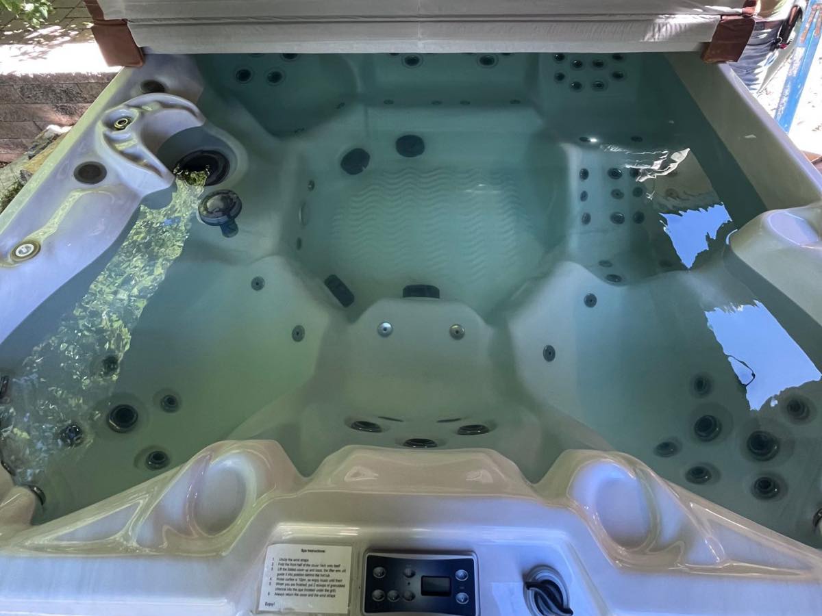 The same hot tub with clear, balanced water after a regular weekly visit